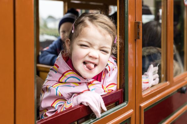Valley Railway girl on carriage poking tongue out at camera